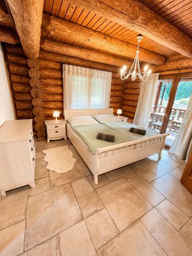 a bedroom with a bed in a log cabin at Chalet Velora in Oščadnica