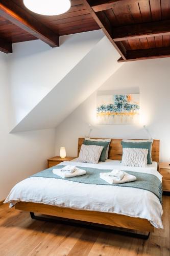 a bedroom with a large bed with two towels on it at Apartmán na Pasekách in Bystrzyca