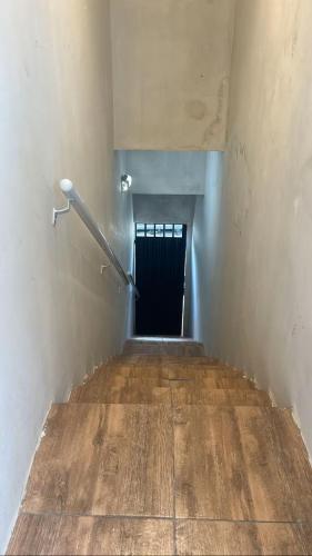 a stairway with a black door in a building at Loft Moderno in Mossoró