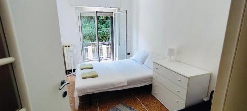 a small bedroom with a bed and a window at Private Space near City Center in Genoa