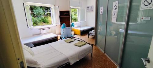 a hospital room with a bed and a window at Private Space near City Center in Genoa