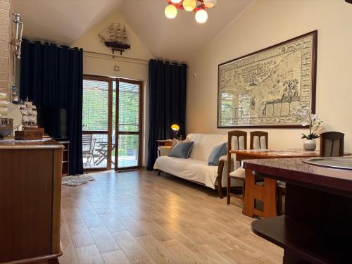 a living room with a couch and a table at Apartamenty NAUTICA Rowy, 150m od plaży in Rowy