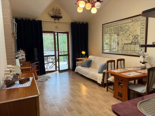a living room with a couch and a table at Apartamenty NAUTICA Rowy, 150m od plaży in Rowy