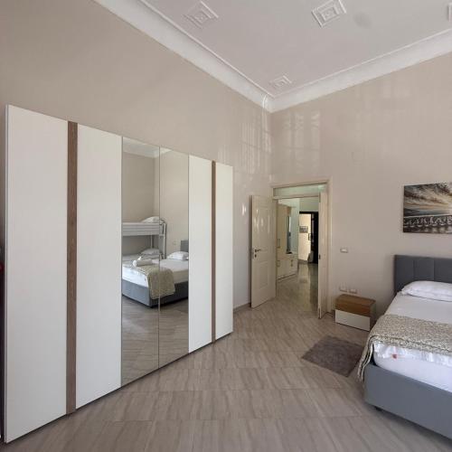 a bedroom with two beds and a mirror at Star Apartment 2- Spacious in the heart of Durres in Durrës
