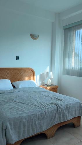 a bedroom with a large bed with a wooden headboard at Residencia manatial in La Mira