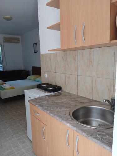 a kitchen with a sink and a counter top at vila Rosmarin in Dobra Voda