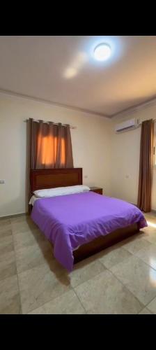 a bedroom with a large purple bed in a room at Ghazala resort in Marsa Matruh