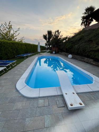 a large blue swimming pool in a yard at Tenuta Paradiso del Monferrato in Portacomaro