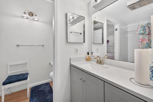 a bathroom with a sink and a mirror at Muirs Chapel Retreat in Greensboro