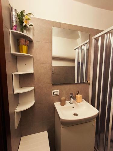 a bathroom with a sink and a mirror at Calin Apartment in Turin
