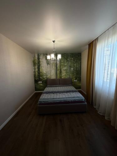 a bedroom with a bed in the middle of a room at 56 Жемчужина in Odesa