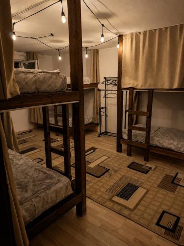 a room with three bunk beds in it at Pure Sleep in Prizren