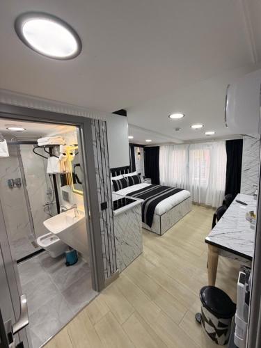 a hotel room with a bed and a bathroom at TAKSİM LARİSSA RESİDENCE in Istanbul