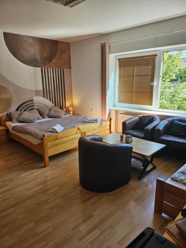 a living room with a bed and a couch at Byron in Zlaté Moravce