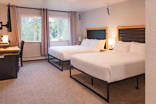 a hotel room with two beds and a window at Highliner Suites Hotel in Anchorage