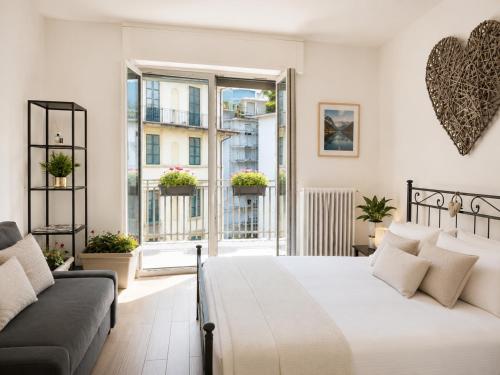 a bedroom with a large bed and a couch at MARY HOUSE Central Station Large Apartment in Sondrio