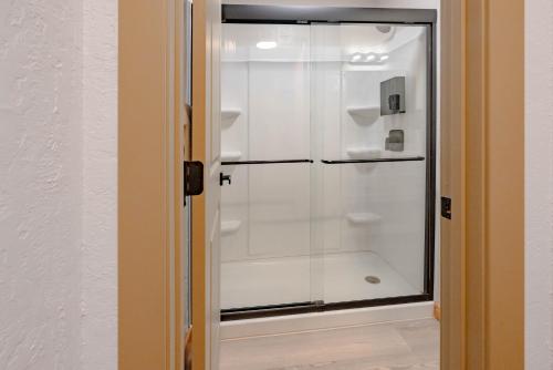 a glass shower door in a room at Highliner Suites Hotel in Anchorage