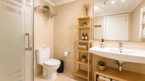 a bathroom with a toilet and a sink at Apartment with pool in Cala Millor in Cala Millor