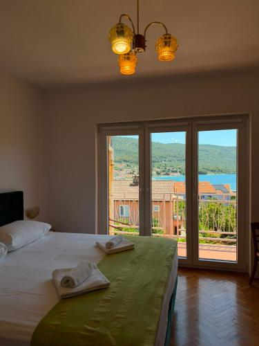 a bedroom with a bed with two towels on it at Apartments Marija in Cres