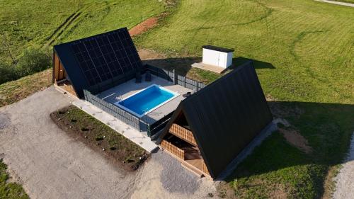 an overhead view of a house with a swimming pool at Grmec Cabin Rental in Podgradina