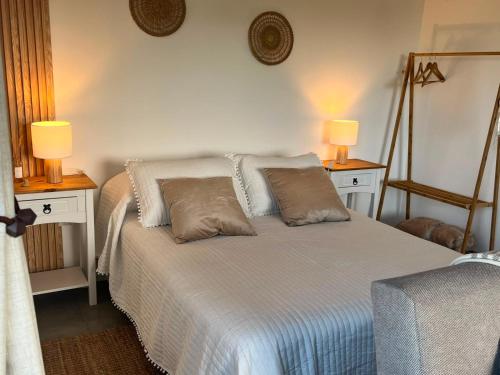 a bedroom with a bed with two lamps on it at Carmela, Colonia Estrella in Carmelo
