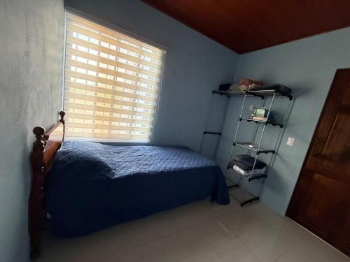 a bedroom with a bed and a window at El Refugio de Montenegro in Montenegro