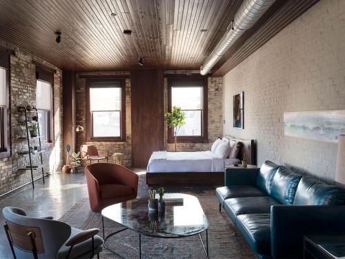 a living room with a couch and a bed at Wm. Mulherin's Sons Hotel in Philadelphia