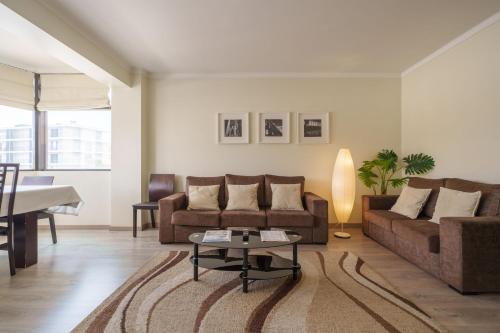 a living room with a couch and a table at StaynFeel 03 in Fátima