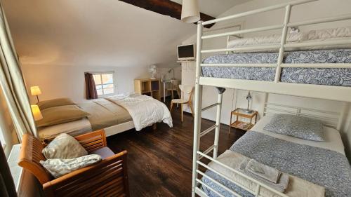 a bedroom with two bunk beds and a desk at Maison Corcovado in Paray-le-Monial