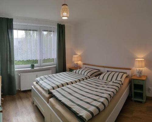 a bedroom with two beds and a window at Apartman AK Slatinany in Chrudim