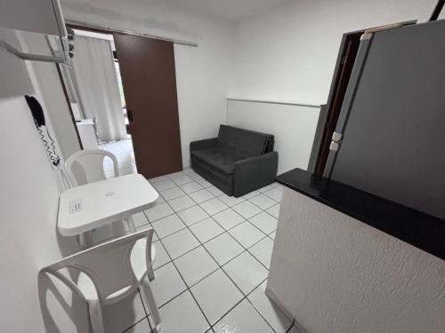 ein kleines Zimmer mit einem Stuhl und einem Sofa in der Unterkunft Charme 239 in Natal