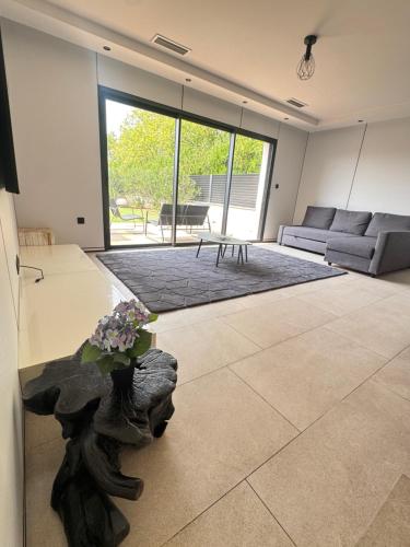 a living room with a couch and a table at villa sam in Feyzin