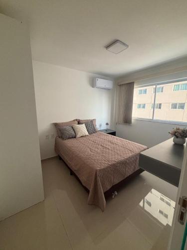 a bedroom with a bed and a window at Studio Design 305 in Sobral