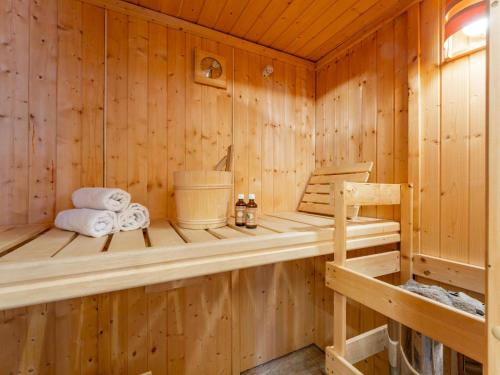 a wooden sauna with towels and a chair in it at Heidi und Peter in Hohentauern