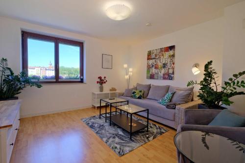 a living room with a couch and a table at FeWo Alte Mainbrücke in Würzburg