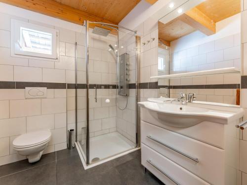a bathroom with a shower toilet and a sink at The Laerch in Hohentauern