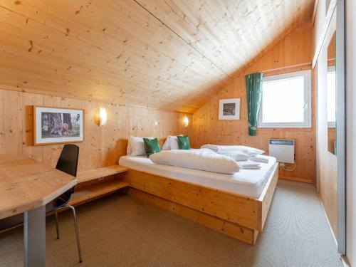 a bedroom with a bed in a wooden cabin at The Laerch in Hohentauern