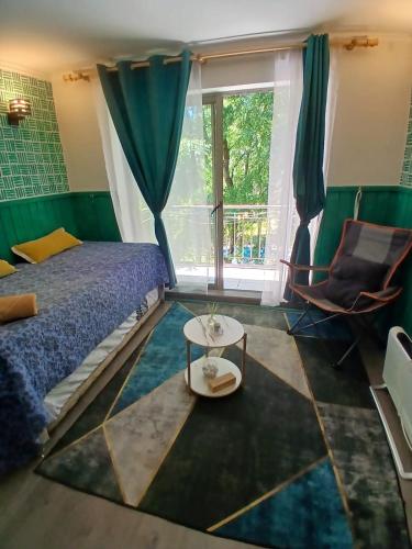 a bedroom with a bed and a table at Departamento Pucon Parque in Pucón