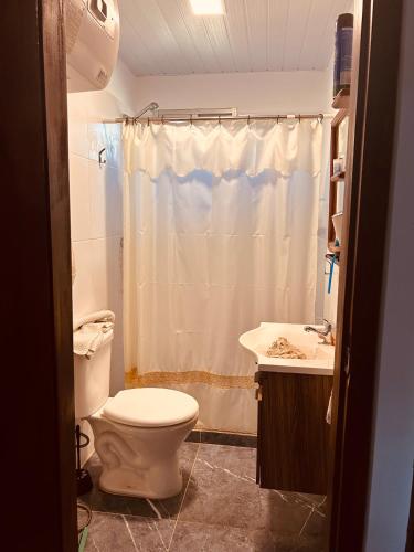 a bathroom with a toilet and a sink and a shower at Tejanos in La Paloma