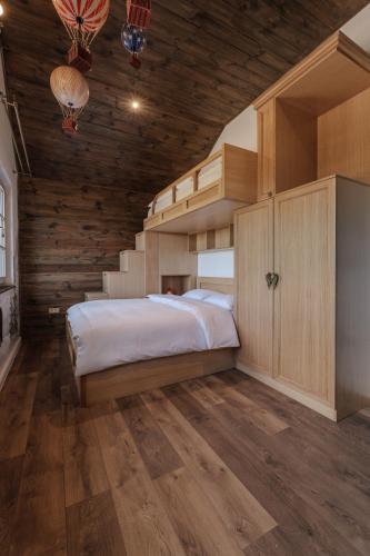 a bedroom with a bed in a room with stairs at Motherland Chalets in Žabljak