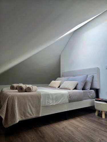 a bedroom with a bed with towels on it at Domus Viriato in Viseu