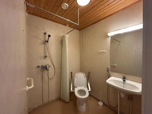a bathroom with a toilet and a sink at Private apartment in Kokkola