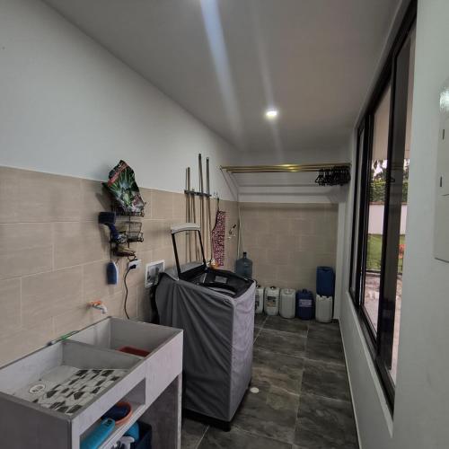 a kitchen with a counter and a sink in a room at Villa Conejo Miraflores in Chinauta