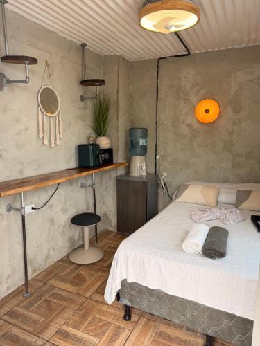 a bedroom with a bed and a table and a chair at Karma Muse Hotel in La Libertad