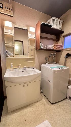 a bathroom with a sink and a mirror at 永山邸 in Asahikawa