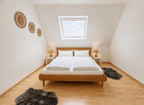 a bedroom with a bed with two tables and a window at Fewo ONE - by Europapark in Rust