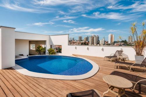 a swimming pool on the roof of a house with a view at Hotel Cassino Tower Piracicaba by Nacional Inn in Piracicaba