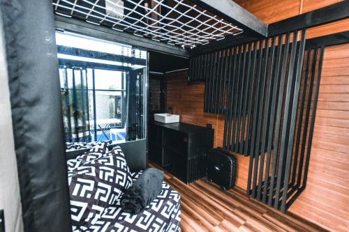 a room with a bed and a balcony at Private Cabin for Quiet, Extended, Freescape Stays in Cavinti