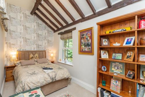 a bedroom with a bed and a book shelf at Picket Post House Accommodation in Catterall