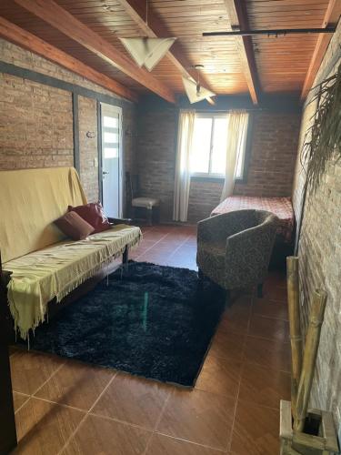 a living room with a couch and a chair at Tres Raíces in Miramar